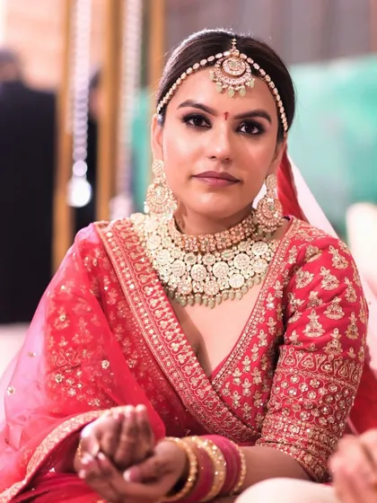 A close-up of the bride during the ceremony. Her makeup is flawless, with a focus on enhancing her natural beauty while she participates in the rituals.