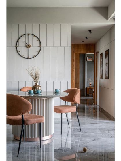 This perspective shows how the dining area flows into the rest of the apartment. The consistent marble flooring and wood accents in the hallway create a unified feel, demonstrating my approach to holistic spatial planning where every inch is considered.