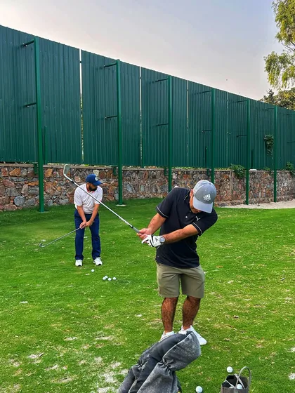 Two golfers work on their chipping and pitching, honing their skills in our specialized short game area.