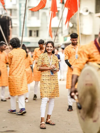 The color version of the smiling cymbal player, her happiness shining.