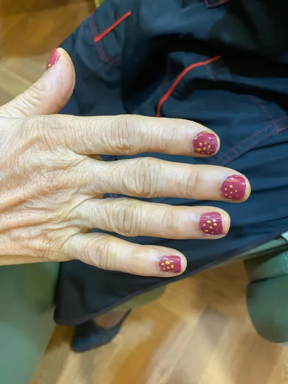The beautiful result of our Ayurvedic manicure on a senior client, finished with our non-toxic, nourishing nail polish.
