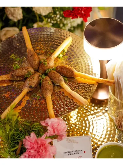 Murg Ganna Kebabs, where minced chicken is molded onto a sugarcane stick before grilling. This innovative technique infuses the kebab with a subtle sweetness and provides a natural, edible skewer.