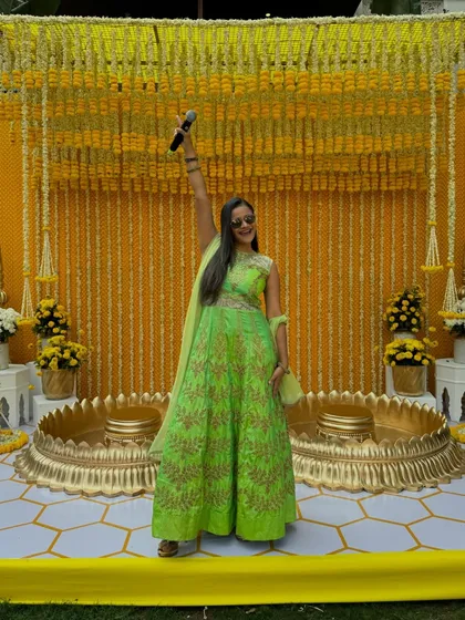 My vibrant green outfit for a Haldi ceremony, standing out beautifully against the traditional yellow decor.