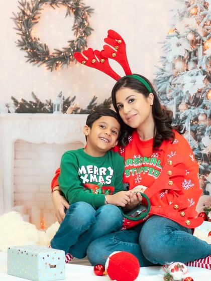 A mother and son get into the festive spirit with fun props during their Christmas mini session.