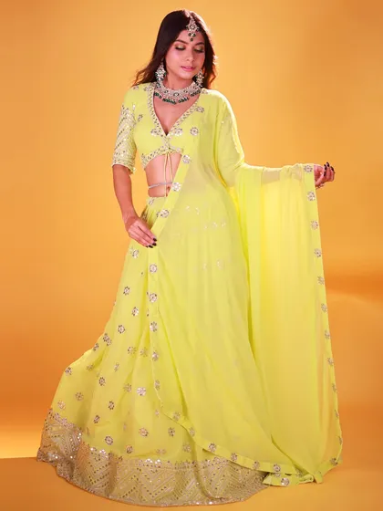 A studio shot focusing on the flow and drape of the neon green lehenga. The model's pose allows the fabric to move, and the lighting captures the movement beautifully.