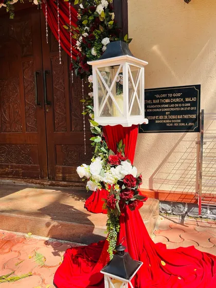 A close up of the details from our church wedding decor. A white lantern stands among the floral arrangements, adding a touch of classic charm to the entrance.