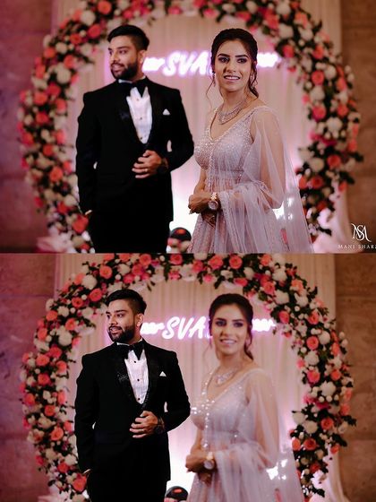 Ankit and Shreya posing for a classic engagement portrait in front of a floral arch.