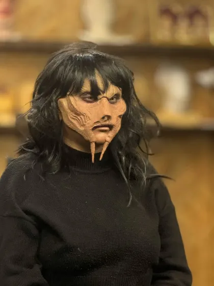 The unpainted prosthetic applied to the model, showing the underlying sculpted form.
