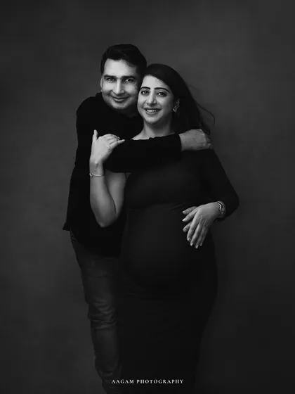 The couple together, sharing a happy moment. This black and white portrait is a timeless keepsake of their journey to parenthood.