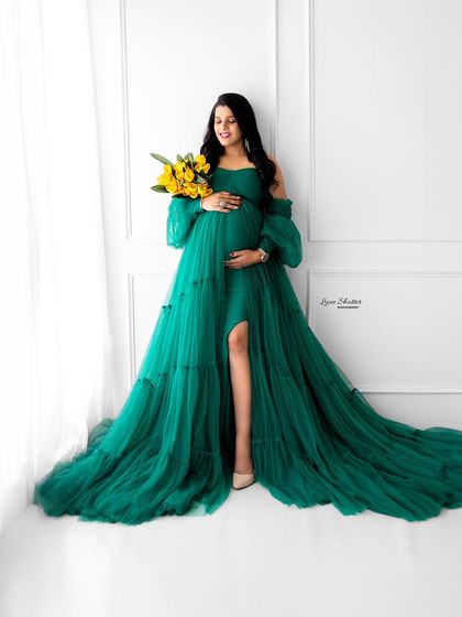 The rich emerald green of this tiered tulle gown is simply captivating. Paired with a simple prop like these yellow flowers, it creates a vibrant and joyful portrait.