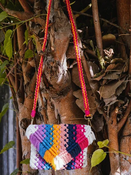 Let's add a pop of color to your day! 🌸 This vibrant, multi-color macrame sling bag is such a joy to make and wear. I wove together shades of purple, blue, orange, and pink to create this unique piece. It comes with a colorful strap and is perfect for adding a fun, bohemian touch to any outfit.