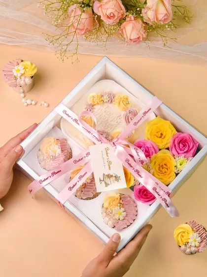 A lifestyle shot of hands holding a bakery gift box, adding a human touch to the product.