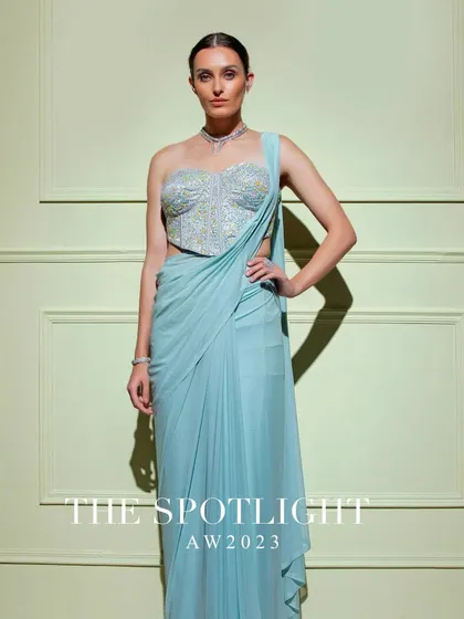 A full shot of the powder blue drape saree, paired with a beautifully embroidered corset blouse for a look of serene elegance.