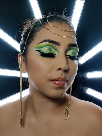 This dramatic Arabic eye makeup features a vibrant green and a bold, extended winged liner. This style is all about creating an elongated, almond-shaped eye and isn't afraid of using colour.