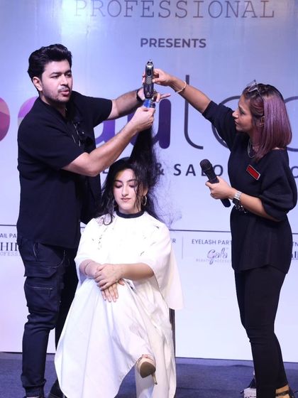 Working with an assistant on stage to create a voluminous, textured look. Teamwork makes the dream work in these high-pressure live shows.