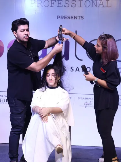 Working with an assistant on stage to create a voluminous, textured look. Teamwork makes the dream work in these high-pressure live shows.