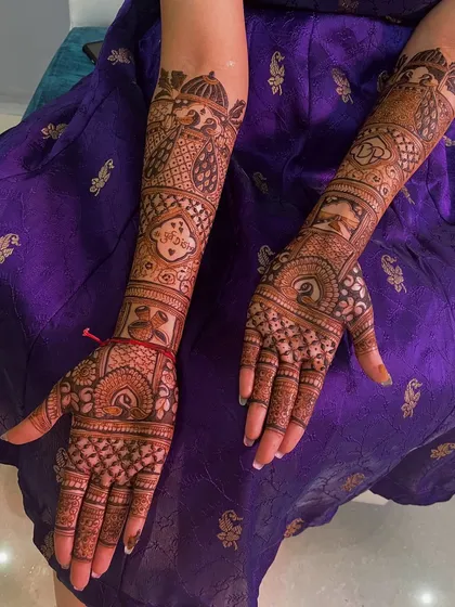 A full bridal design for a happy client. The arms are adorned with peacock and doli motifs, along with the couple's initials, creating a personalized and beautiful story.