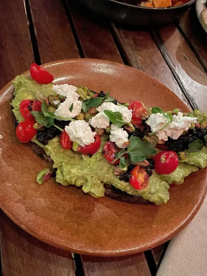 This is a wonderfully nourishing plate. Mashed avocado and cheese on a base of sweet potato, topped with greens and cherry tomatoes. It's a perfect combination of healthy fats, protein, and complex carbohydrates.