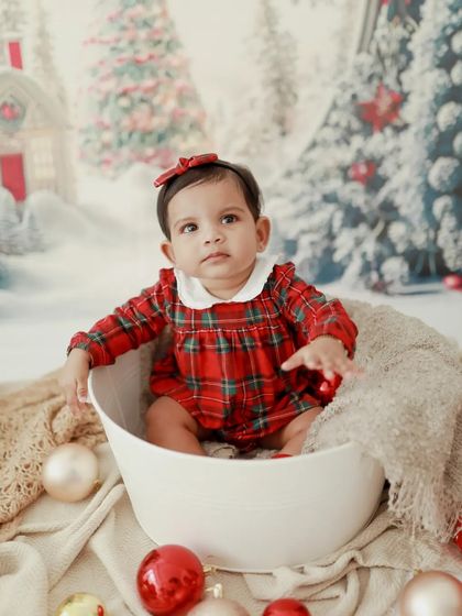Celebrating the magic of Christmas. This little girl in her festive outfit is the perfect holiday gift.
