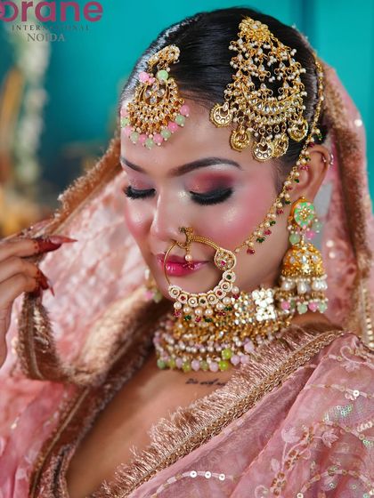 A detailed close-up of the pastel-toned jewelry and the soft, smoky eye makeup, perfect for a festive celebration.