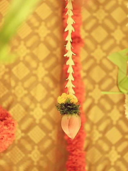 A close-up of the delicate hanging elements. Here, jasmine strings and lotus buds are combined with marigold balls, showing the intricate craftsmanship involved in creating our traditional decor.