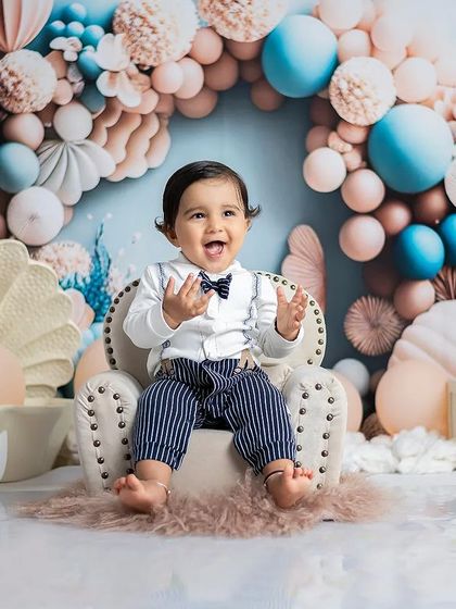 The pure happiness of turning one. This little boy's joyful expression is perfectly captured in our sea-pastel themed set.