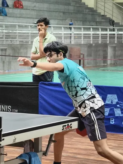 A young player executing a forehand drive during the tournament, representing the next generation of champions.