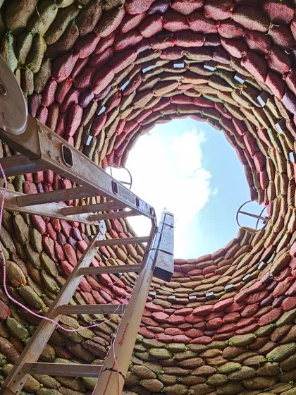 A look up into the sky from inside a nearly completed earthbag dome. This powerful image showcases the scale and beauty of what you can create with simple, sustainable materials like soil-filled sacks.