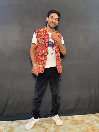 A confident pose in a traditional jacket, ready to hit the dance floor for Garba night.