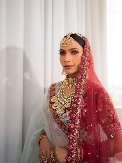 This side profile highlights the elegant hair and the way the dupatta frames the face, with the makeup providing the perfect focal point.