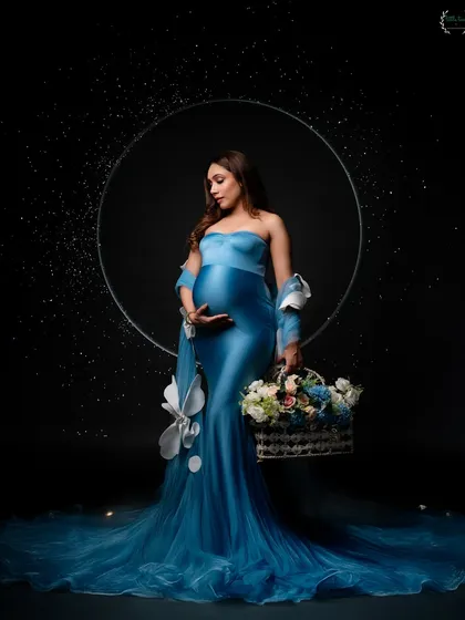 A creative solo portrait using a ring light and a basket of flowers to create a magical, almost celestial, look.