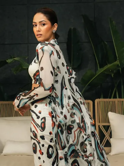 An over-the-shoulder shot that captures the movement of the flowing cape and adds a dynamic element to the portrait.