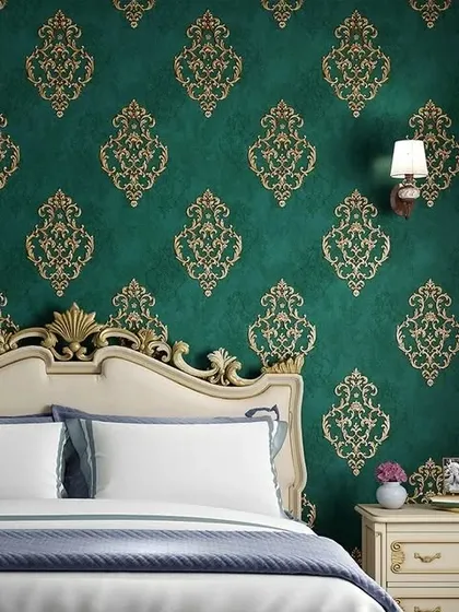 An elegant bedroom featuring a classic damask wallpaper in a rich emerald green and gold. This traditional pattern adds a luxurious and royal feel to the space.