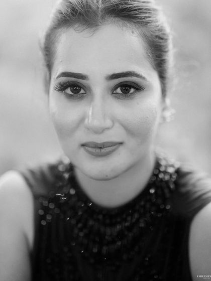 A simple, beautiful, and direct black and white portrait. This close-up of Akanksha captures her natural beauty and a moment of calm connection with the camera.