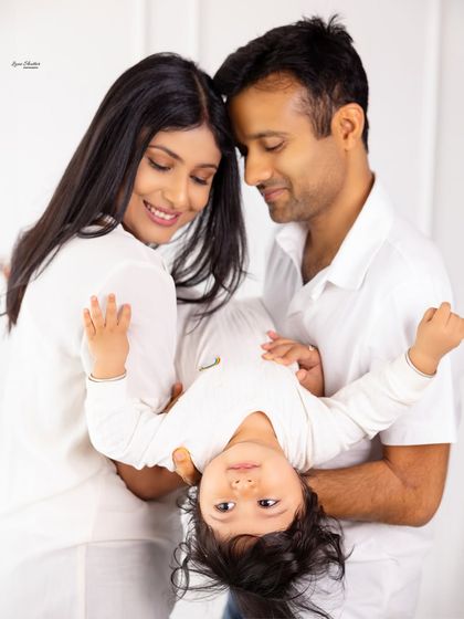 A playful moment during a family session. Holding the baby upside down always results in the best giggles and a photo filled with pure joy.