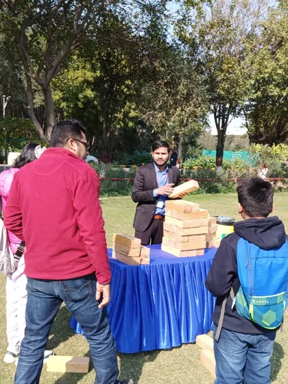 A guest carefully considering their next move in a game of Giant Jenga. It's a game of strategy and steady hands that everyone can enjoy.