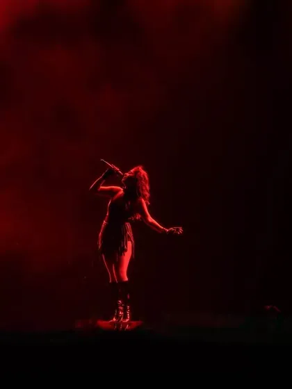 A single artist, a single spotlight, a sea of red. We use dramatic lighting to create intimate, powerful moments even in a massive stadium.