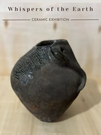 An organic, hand-sculpted vase with a dark, earthy glaze. This piece is from my collection for the 'Whispers of the Earth' exhibition.
