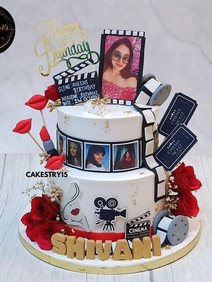 A dazzling two-tier Retro Bollywood theme cake for a wife's birthday. This 3kg chocolate cake is decorated with a film reel, movie clapper, and edible photos for a cinematic tribute.