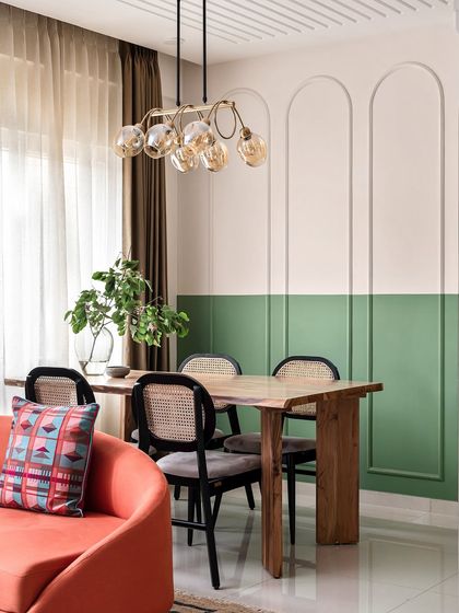 In this dining area, I used arched wall beadings on a dual-toned wall to add a layer of architectural interest and elegance.