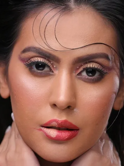 A close-up on the face, showing the details of the eye and lip makeup.
