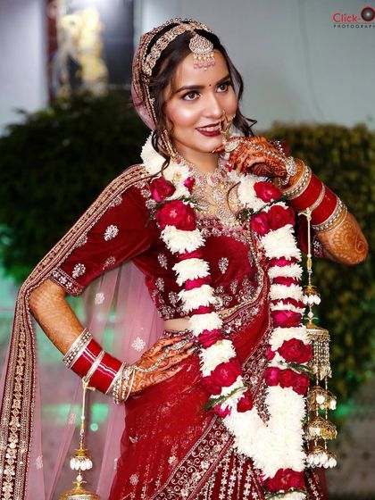 A stylish pose from the same bride, showing off her complete wedding attire and confident smile.