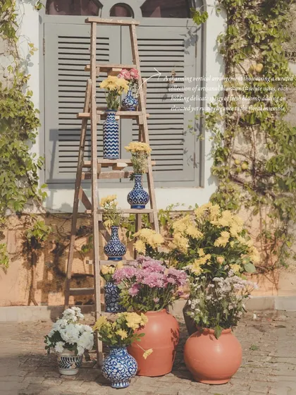 Another angle of the decorative ladder, showcasing how simple, rustic elements can be elevated with beautiful floral arrangements and artisanal vases.