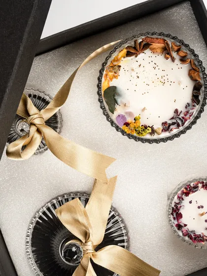 A top-down view of the 'Eternal Elegance: Classic Duo' gift box. The intricate details of the dried floral toppings are visible, showcasing the artistry involved.