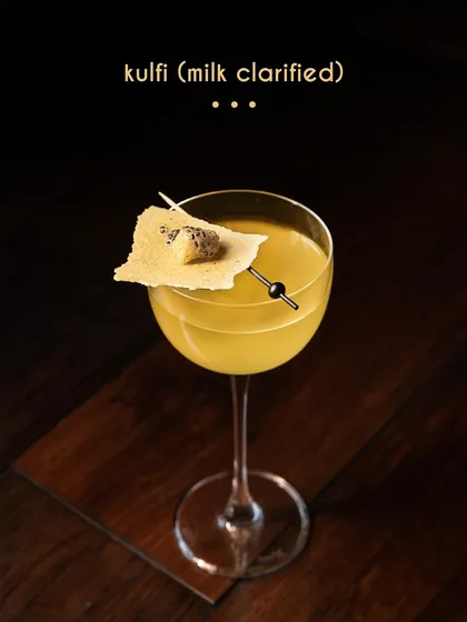 We present our Kulfi cocktail, a nostalgic dessert reimagined as a sophisticated drink. This milk-clarified creation captures the essence of traditional kulfi, blending gin with the aromatic warmth of cardamom, saffron, and almond for a truly unique experience.