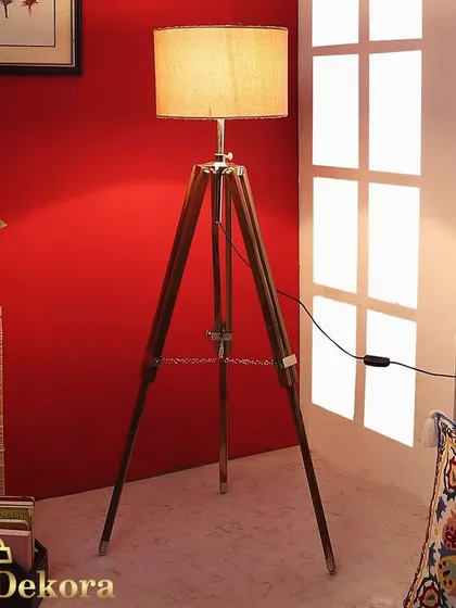 Our classic wooden tripod floor lamp adds a touch of mid-century modern elegance to your home. The sturdy wood construction, complemented by metal accents, provides warm, ambient lighting perfect for a reading nook or office space.