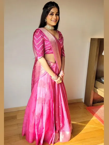 Another look at the pink saree draped as a lehenga, showing how it creates a flattering A-line silhouette. This is a great option for those who want the look of a lehenga with the versatility of a saree.