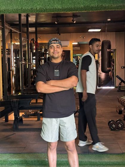 Arms crossed, confident.