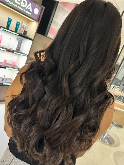 A warm mocha highlight blend with soft long layering. This is a great example of a subtle color that enhances natural beauty and adds a touch of warmth.
