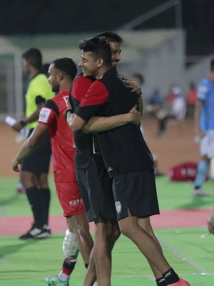 A moment of celebration and a hug with the head coach after a hard-fought match. The emotions of professional sport are what make it so compelling.